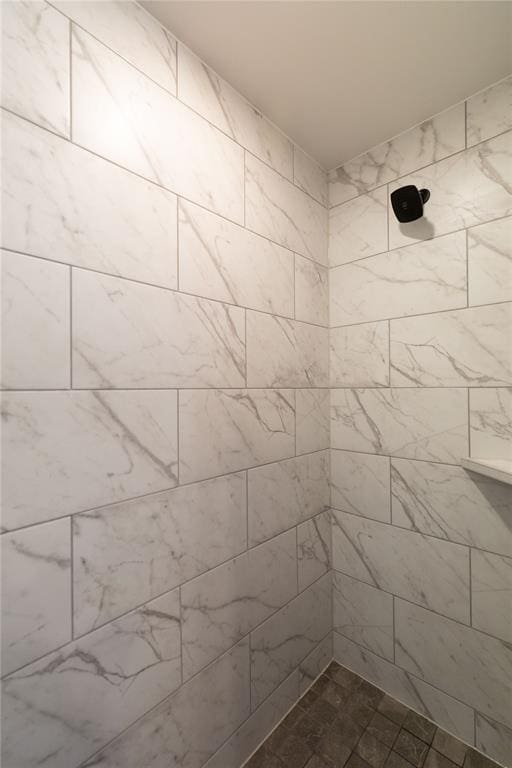 bathroom with a tile shower