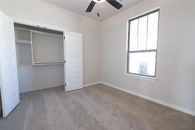 unfurnished bedroom featuring a closet, ceiling fan, and light colored carpet