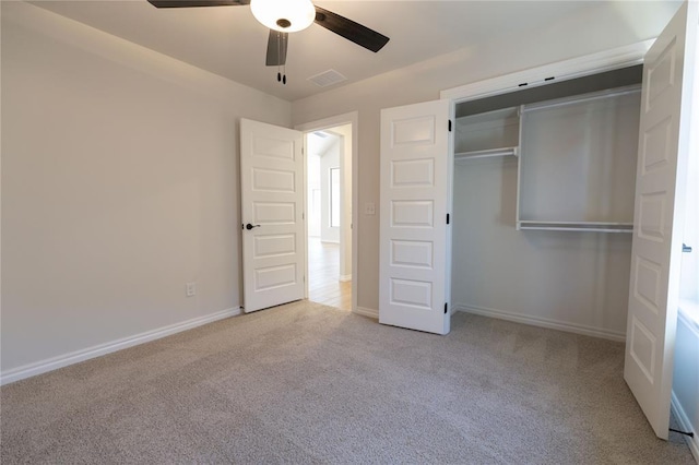 unfurnished bedroom with a closet, ceiling fan, and light colored carpet