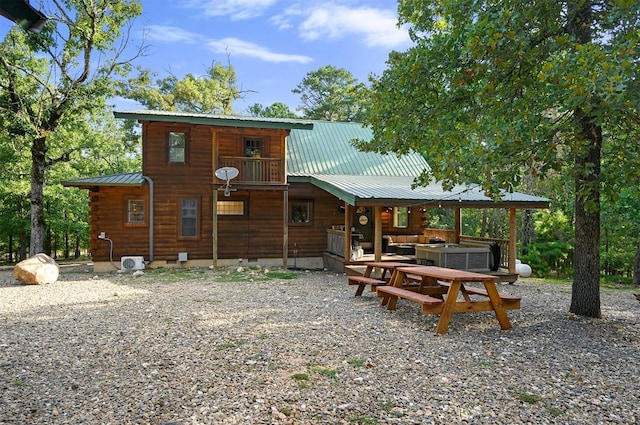 back of property featuring a balcony and an outdoor hangout area