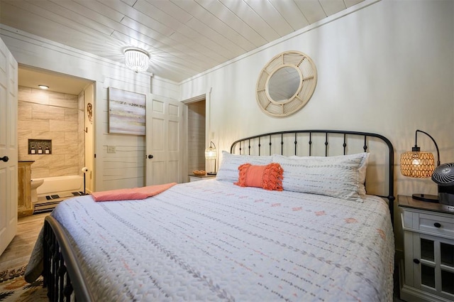 bedroom featuring hardwood / wood-style floors and crown molding