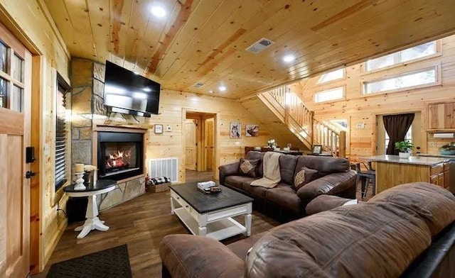 living room with wooden ceiling, dark wood-type flooring, and wood walls