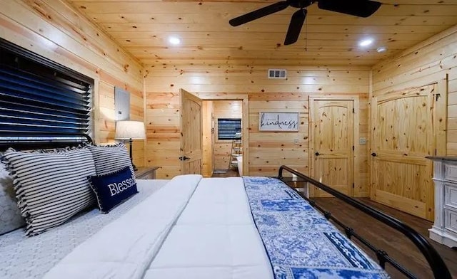 bedroom featuring wooden ceiling and wood walls