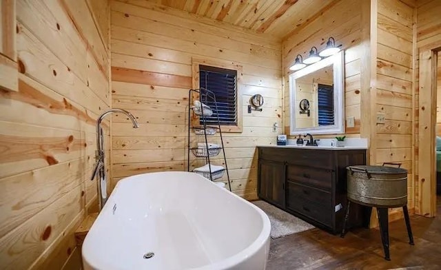 bathroom featuring vanity, wood walls, wooden ceiling, and a tub to relax in