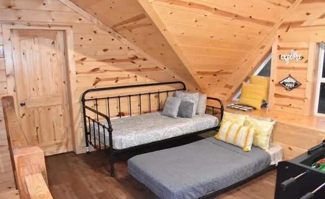 bedroom with wooden ceiling, dark wood-type flooring, and wooden walls