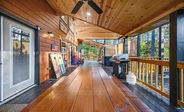 wooden deck with a grill and ceiling fan