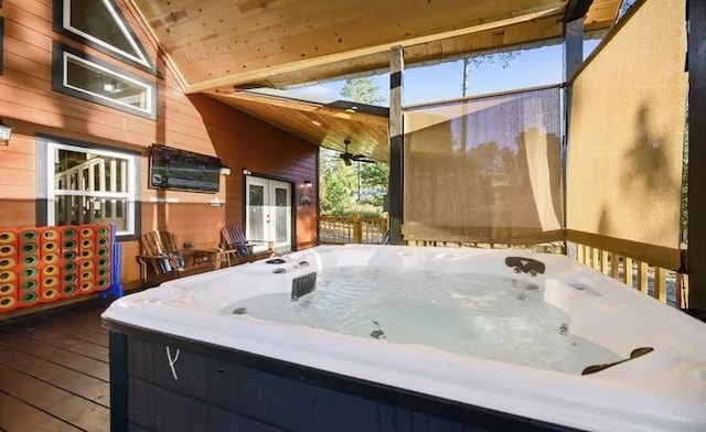 wooden deck featuring a hot tub