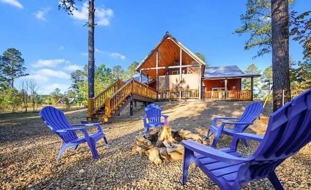 rear view of house featuring a fire pit