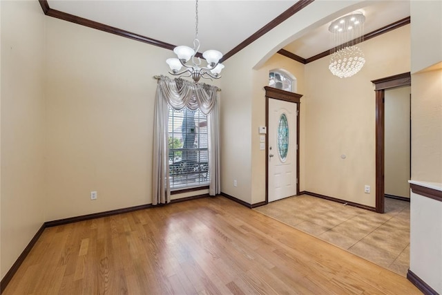 entrance foyer with a chandelier, light hardwood / wood-style flooring, and ornamental molding