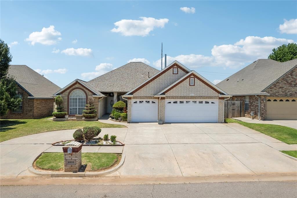 view of front of property featuring a garage and a front lawn