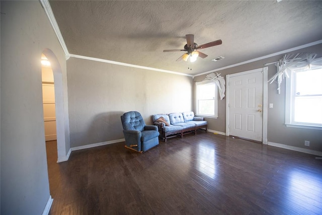 unfurnished room featuring crown molding, dark wood-type flooring, and a textured ceiling