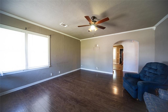 unfurnished room with a textured ceiling, dark hardwood / wood-style floors, ceiling fan, and crown molding