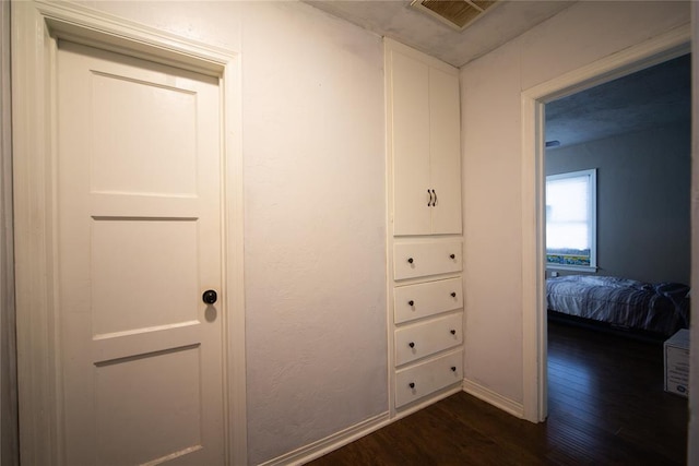 hall with dark wood-type flooring