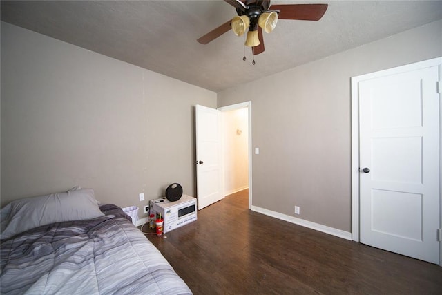 bedroom with ceiling fan and dark wood-type flooring