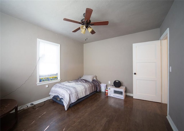 bedroom featuring ceiling fan and dark wood-type flooring