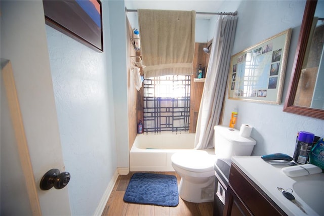 full bathroom with vanity, hardwood / wood-style flooring, toilet, and shower / bath combo with shower curtain