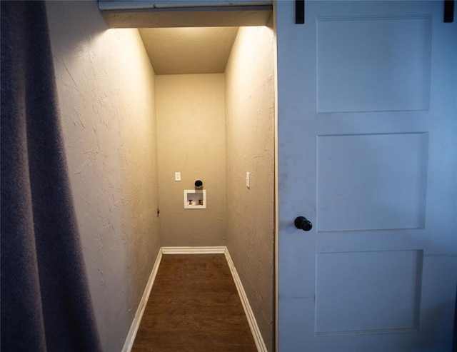 laundry area featuring washer hookup, a textured ceiling, electric dryer hookup, a barn door, and dark hardwood / wood-style floors