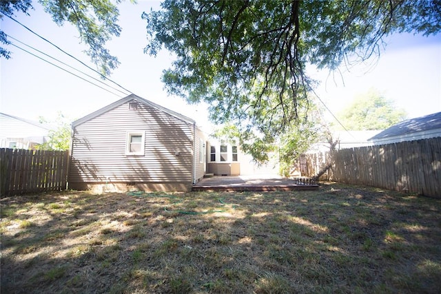 back of house with a yard and a patio