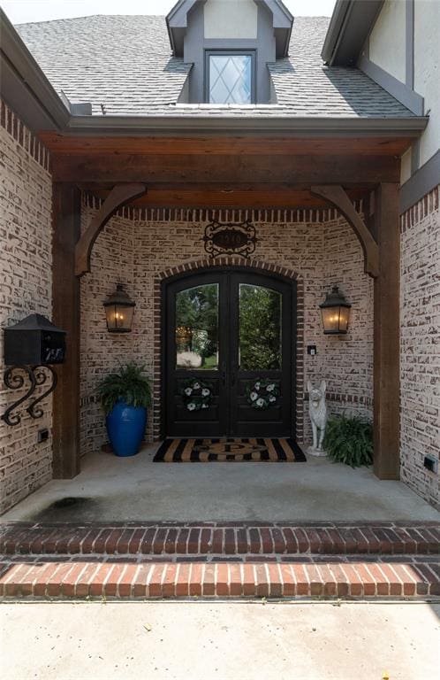 entrance to property with covered porch and french doors