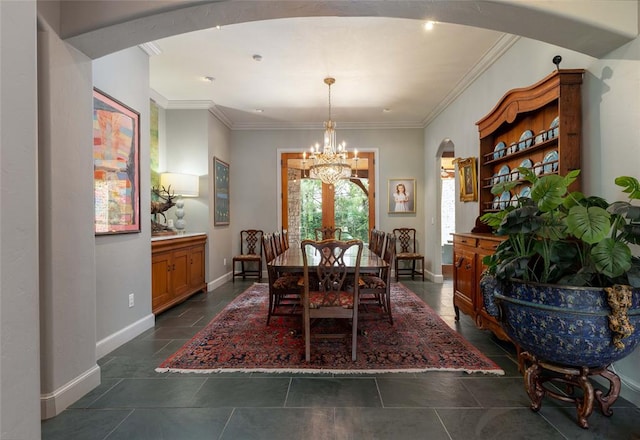 tiled dining area featuring a chandelier and crown molding