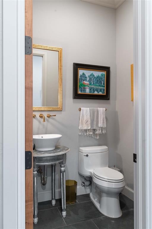 bathroom with tile patterned flooring, toilet, and sink