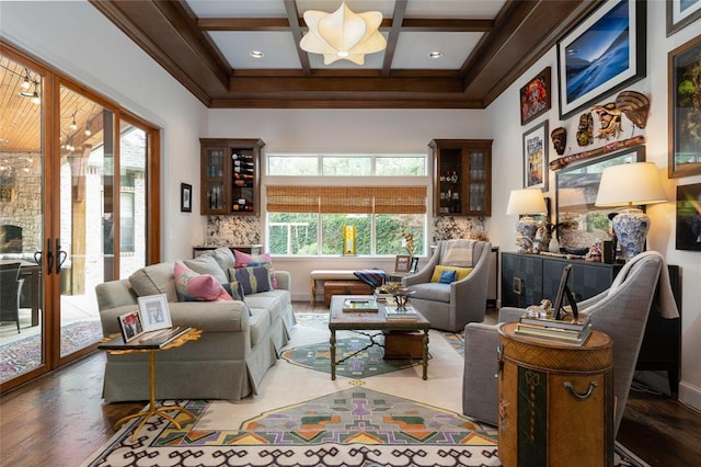 living area featuring french doors, coffered ceiling, crown molding, beam ceiling, and hardwood / wood-style floors