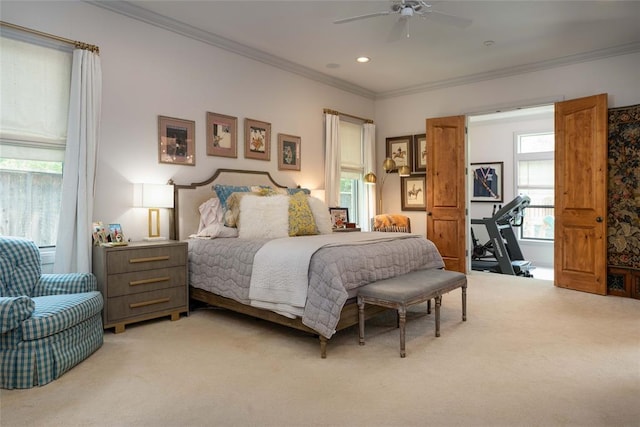 carpeted bedroom featuring ceiling fan and crown molding