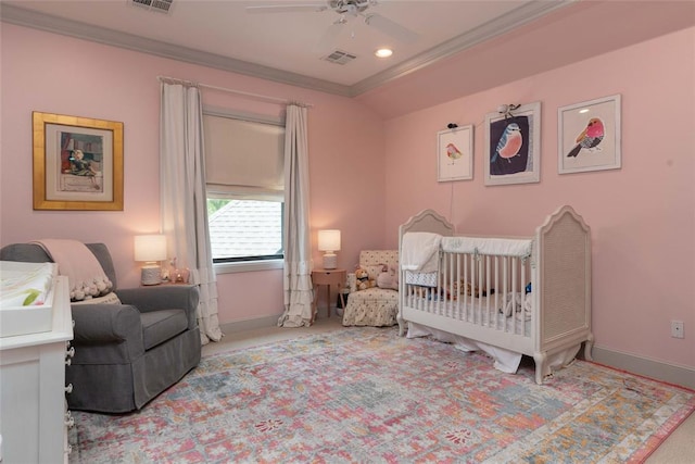 bedroom featuring ceiling fan, light colored carpet, ornamental molding, and a nursery area