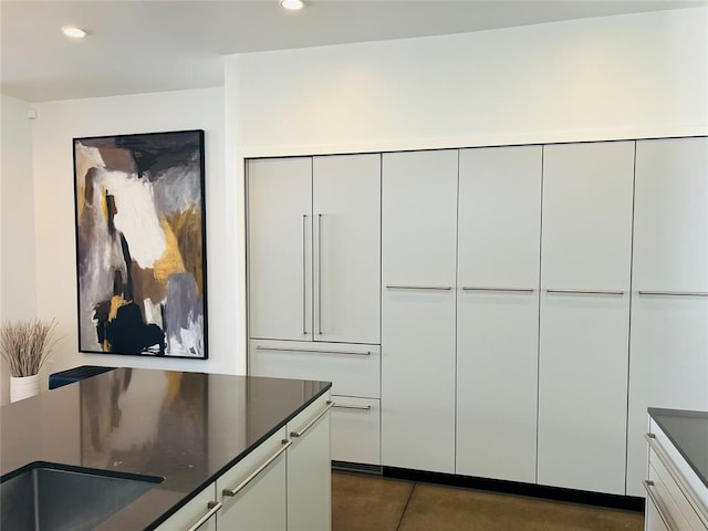 interior space featuring white cabinets and sink