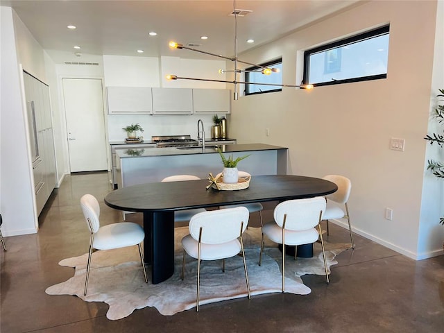 dining space featuring concrete flooring and sink