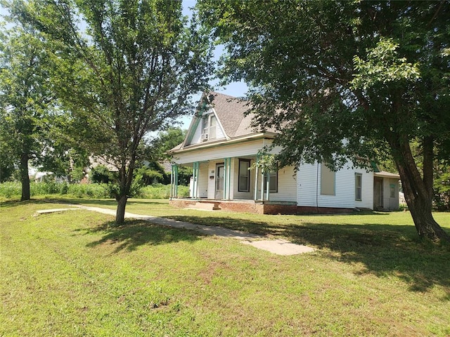 view of front of home featuring covered porch and a front yard