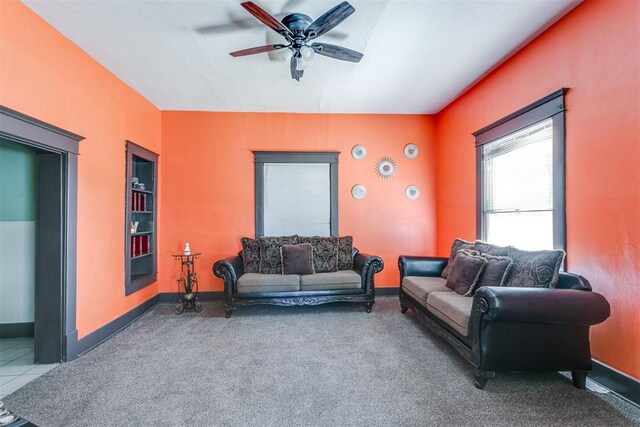 living room with ceiling fan and carpet floors