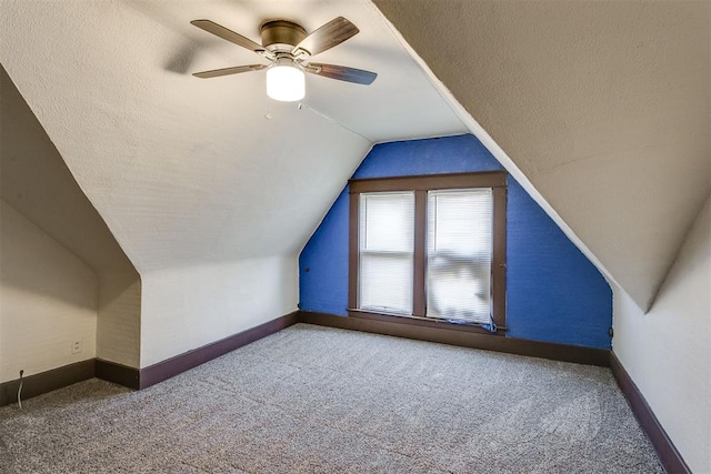 bonus room featuring carpet, ceiling fan, a textured ceiling, and vaulted ceiling