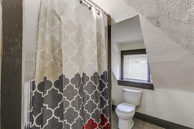 bathroom with tile patterned flooring and toilet