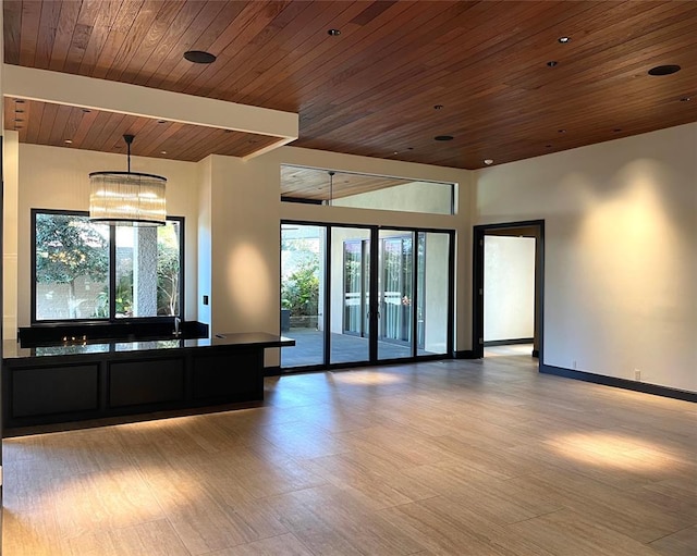 interior space featuring plenty of natural light, light hardwood / wood-style floors, and wooden ceiling