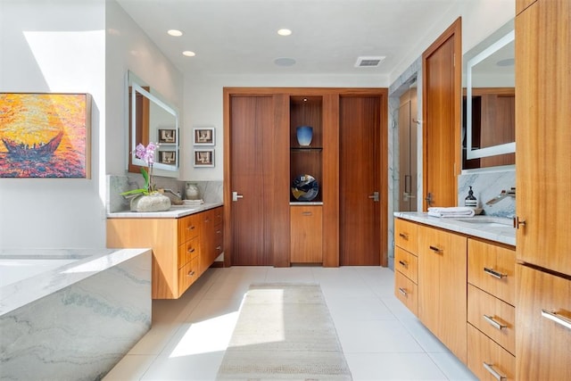 bathroom with vanity, backsplash, and tile patterned flooring