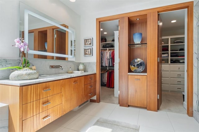 bathroom with tile patterned floors, vanity, and decorative backsplash