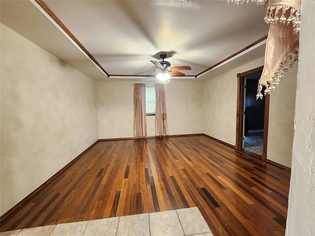 spare room with wood-type flooring, ceiling fan, and crown molding