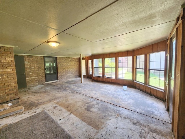 unfurnished sunroom with lofted ceiling