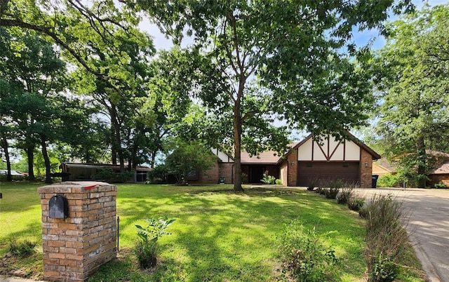 1116 Reid Cir, Seminole, OK 74868 - view of front of house with a front yard, an attached garage, driveway, and brick siding