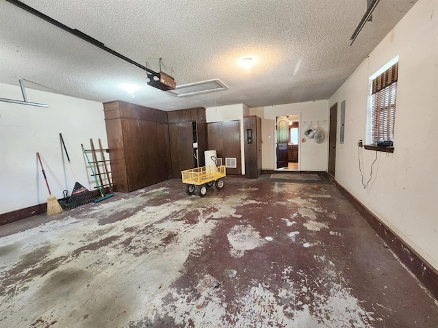 garage featuring electric panel and a garage door opener