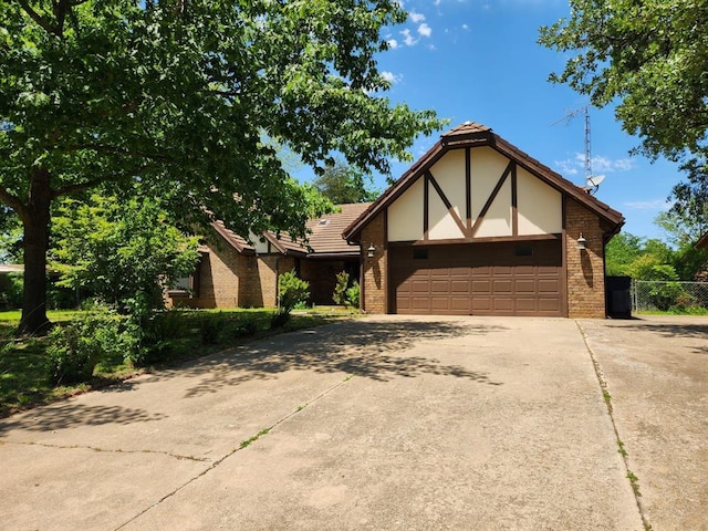 1116 Reid Cir, Seminole, OK 74868 - tudor house with concrete driveway, brick siding, and a garage