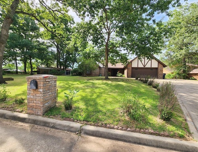 1116 Reid Cir, Seminole, OK 74868 - view of front of home featuring a front lawn, an attached garage, brick siding, and concrete driveway