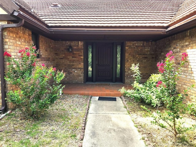 1116 Reid Cir, Seminole, OK 74868 - doorway to property with brick siding and a tile roof