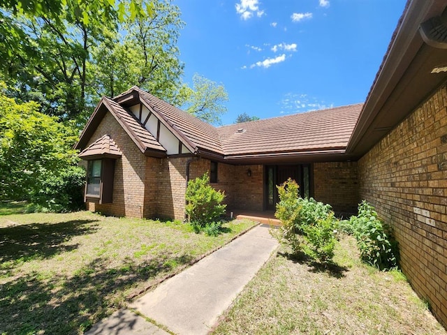 1116 Reid Cir, Seminole, OK 74868 - entrance to property featuring brick siding and a tile roof