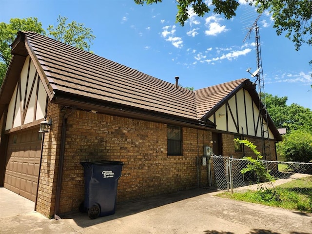 1116 Reid Cir, Seminole, OK 74868 - view of side of property with brick siding and an attached garage