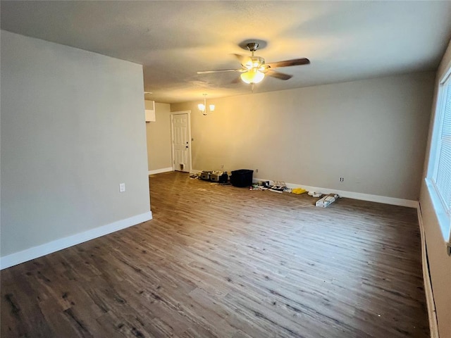 unfurnished room featuring dark hardwood / wood-style floors and ceiling fan with notable chandelier