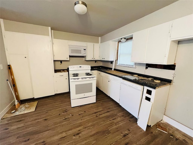 kitchen featuring dark hardwood / wood-style flooring, white cabinets, and white appliances