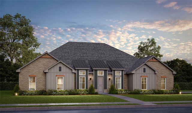 view of front of house featuring brick siding, a shingled roof, board and batten siding, and a lawn