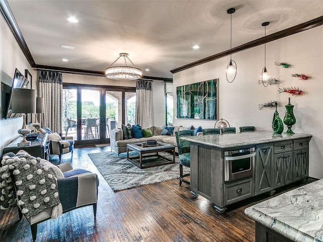 kitchen with light stone counters, ornamental molding, stainless steel oven, dark wood-type flooring, and hanging light fixtures